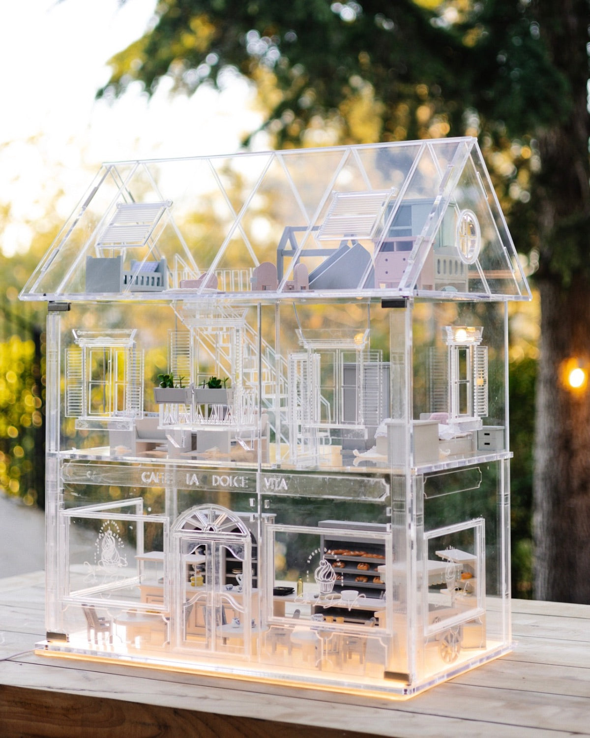 Angled view of the Crystal Rome Collector's Edition showcasing illuminated interiors, handcrafted furniture, and walls.