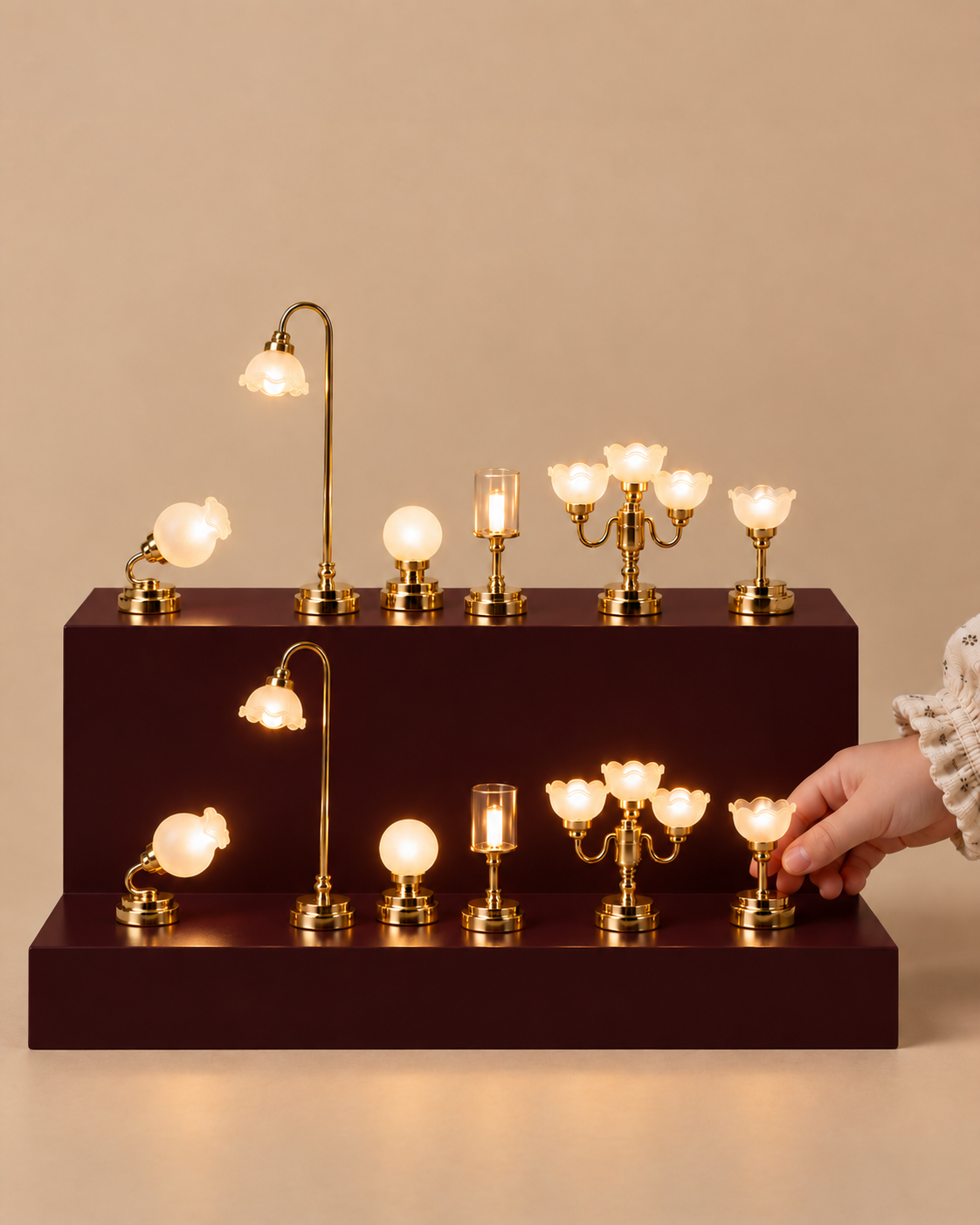 Twelve miniature brass dollhouse lamps arranged on a two-tier burgundy stand.