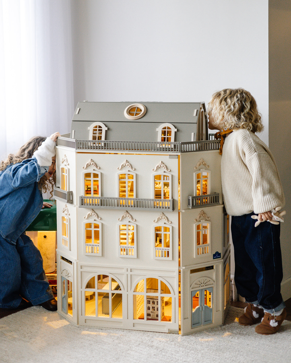 The House of Paris dollhouse draws children in from every side, with its illuminated rooms and detailed interiors on display.