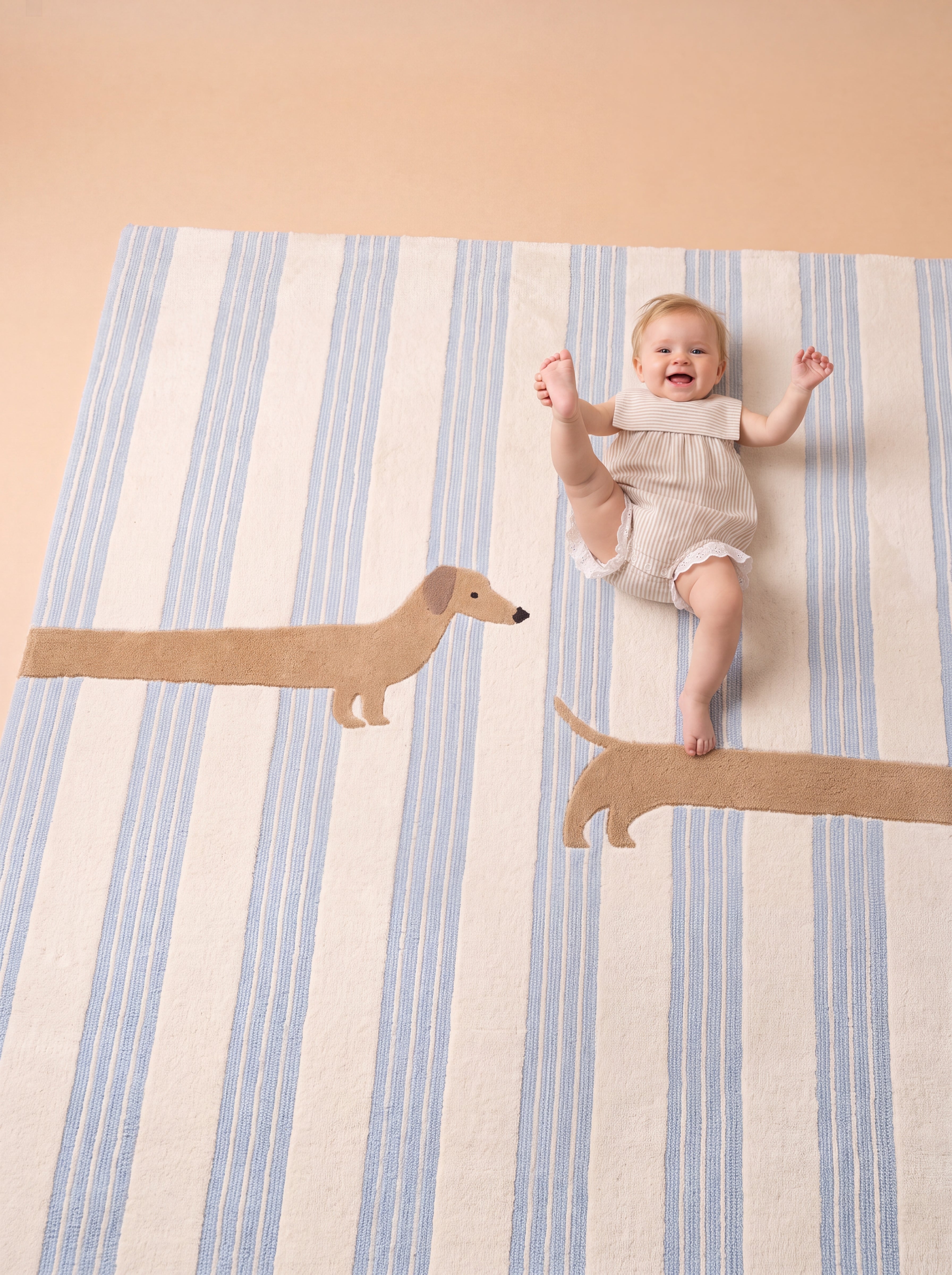 The Dachshund rug with soft blue stripes and a playful dachshund design, shown with a baby lying on the rug.