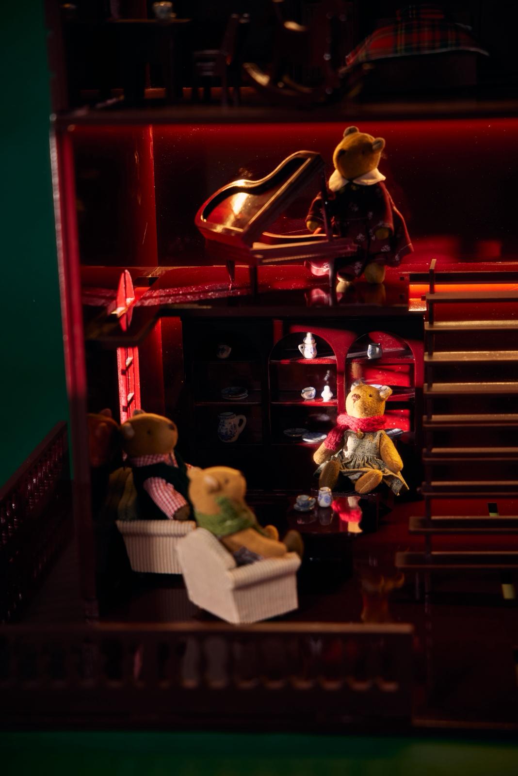 Little Forest Animals House of Bordeaux — red wooden dollhouse glowing with soft light, complete with tiny teddy bears, furniture and textiles, a handmade heirloom for timeless Christmas gifting.