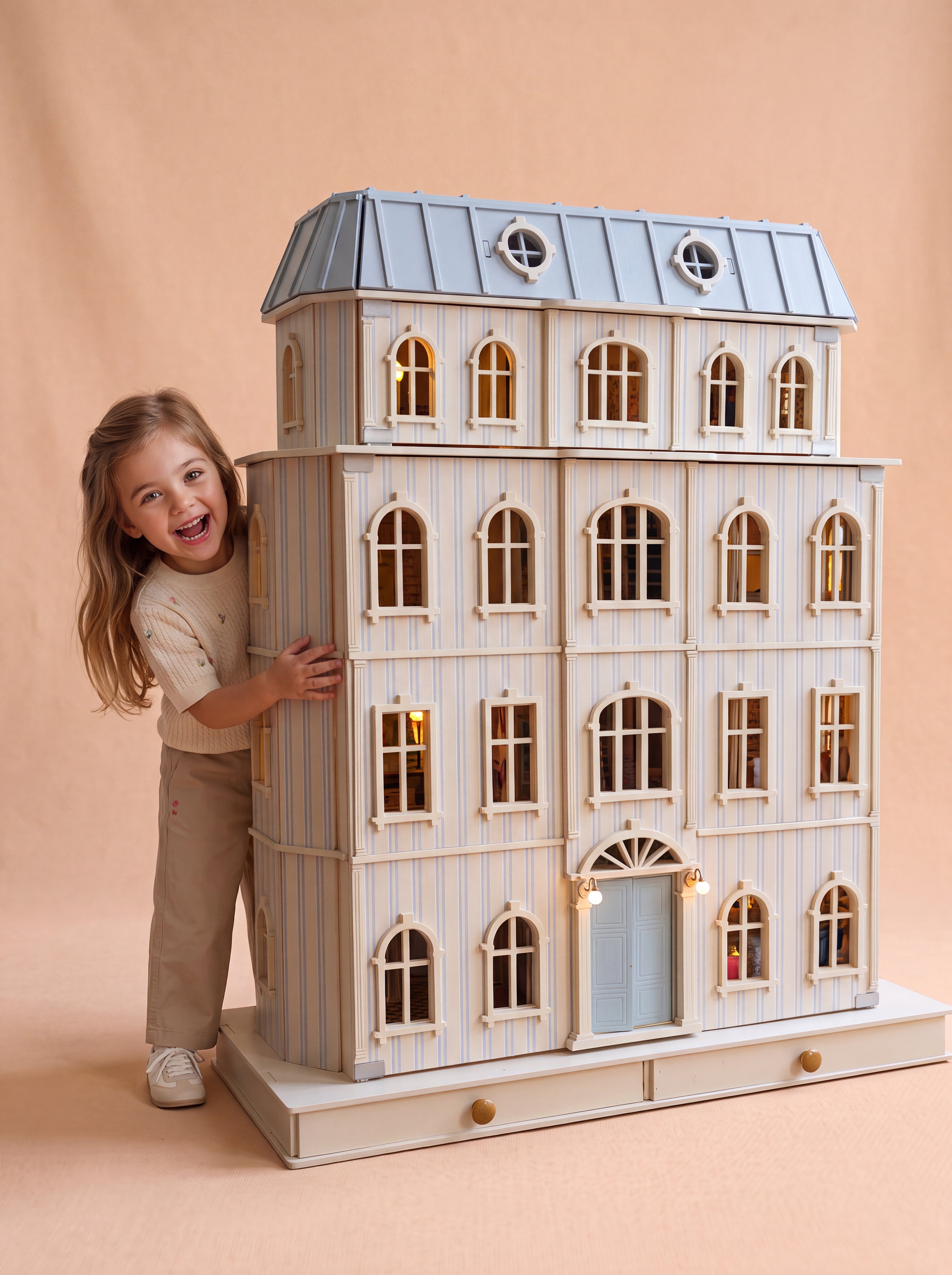 Girl peeking out from behind the House of Monaco, a handcrafted six-storey wooden dollhouse.
