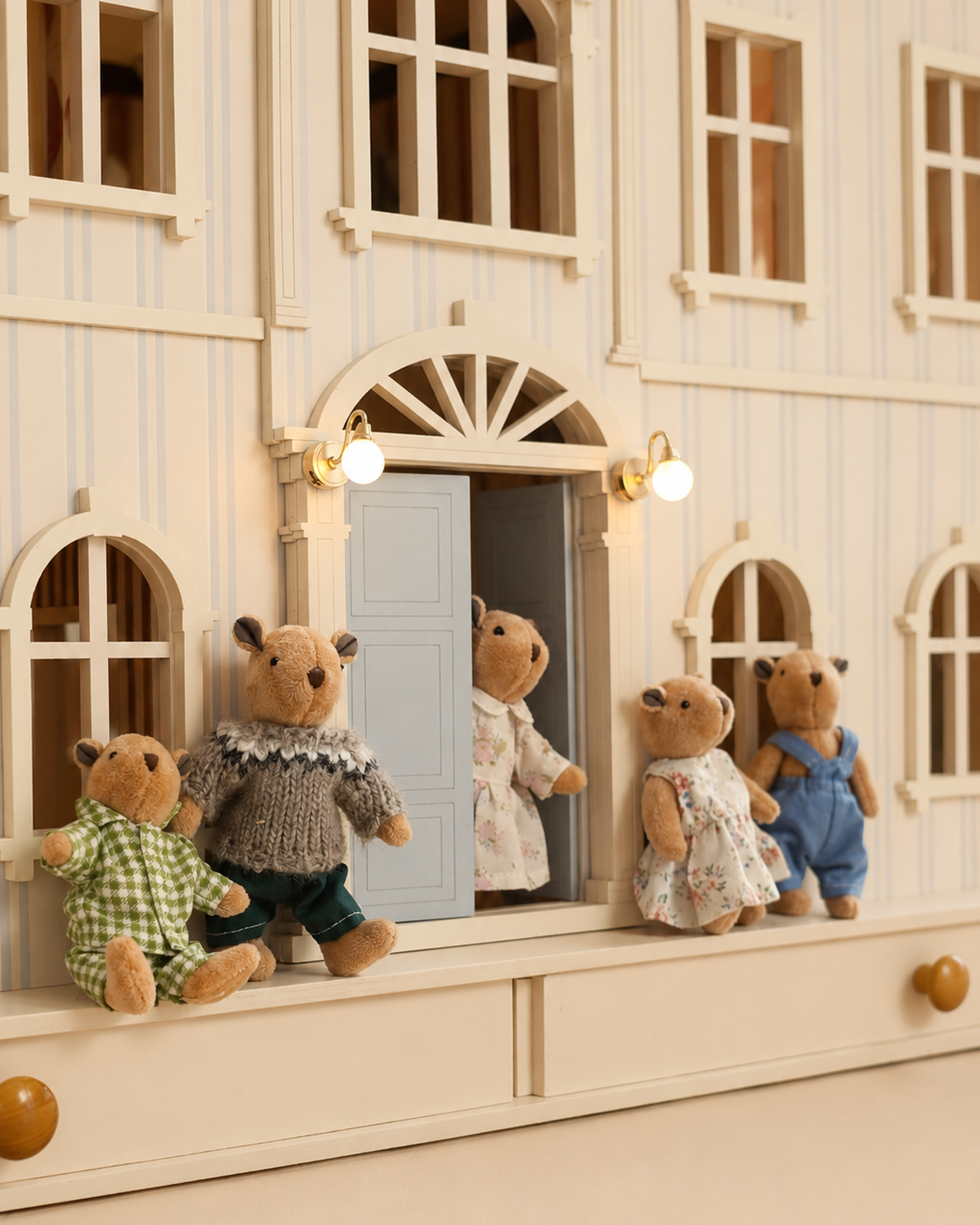 Little Forest Animals bear dolls posed in front of the illuminated House of Monaco dollhouse facade.
