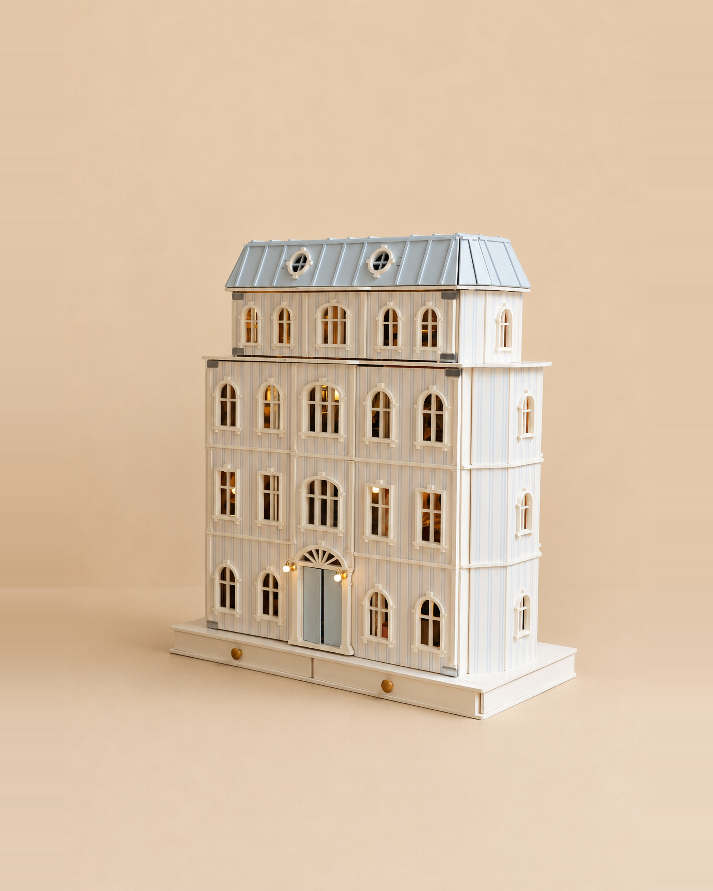 Angled view of the House of Monaco wooden dollhouse highlighting its detailed facade and balconies.