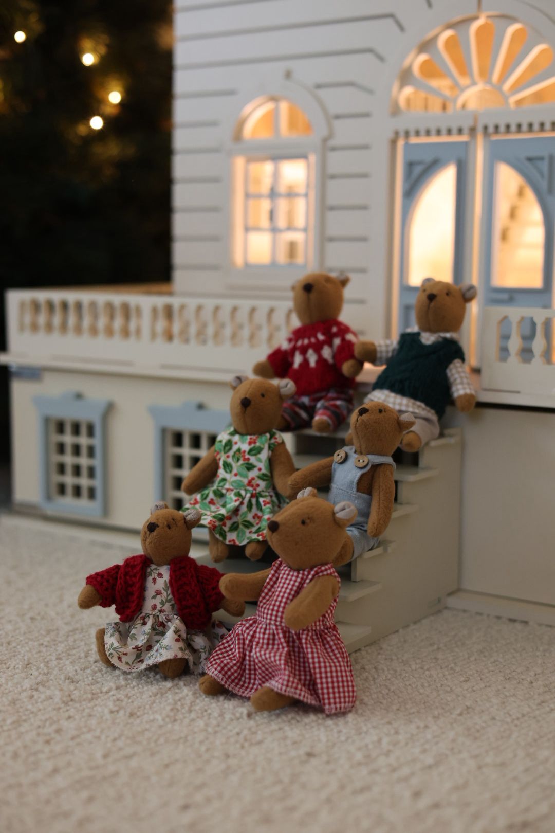 The Thompsons, a New York bear family, sitting inside their West Village dollhouse — a poetic reflection of city life in miniature form