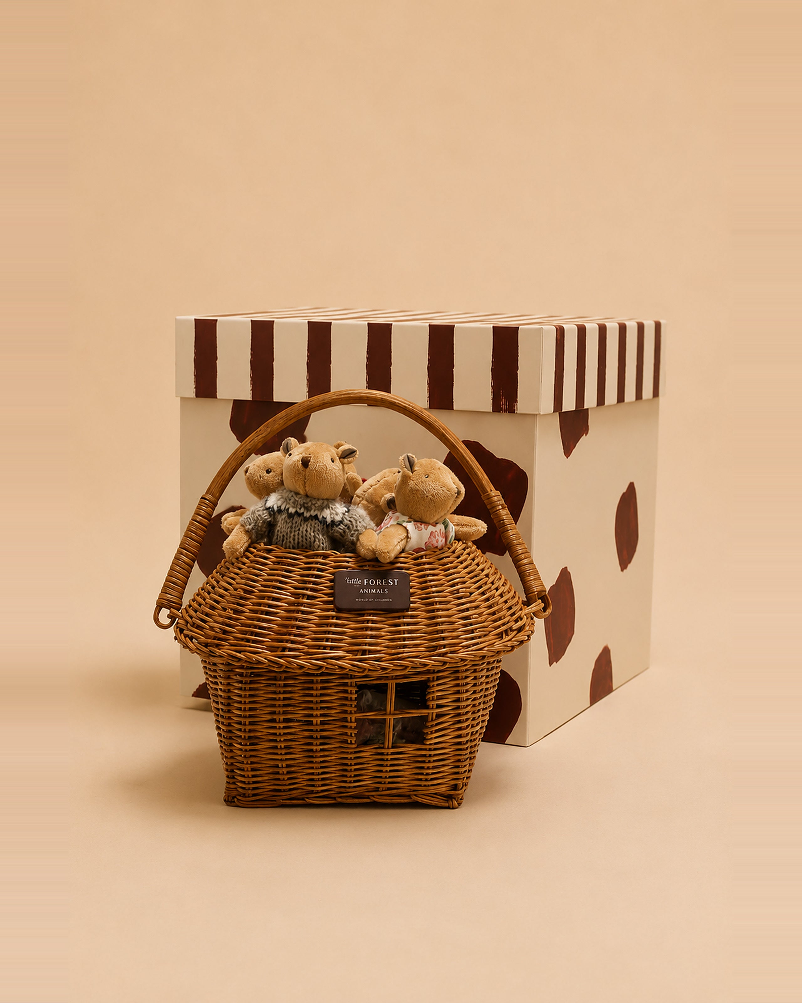 The Thompson Family bear dolls resting in their woven house-shaped basket.