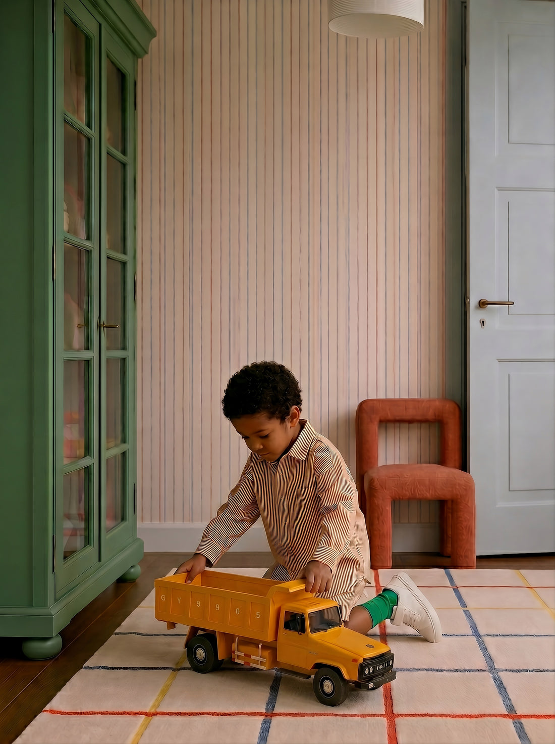 Big Yellow Truck on the floor while a child pushes it across the room.