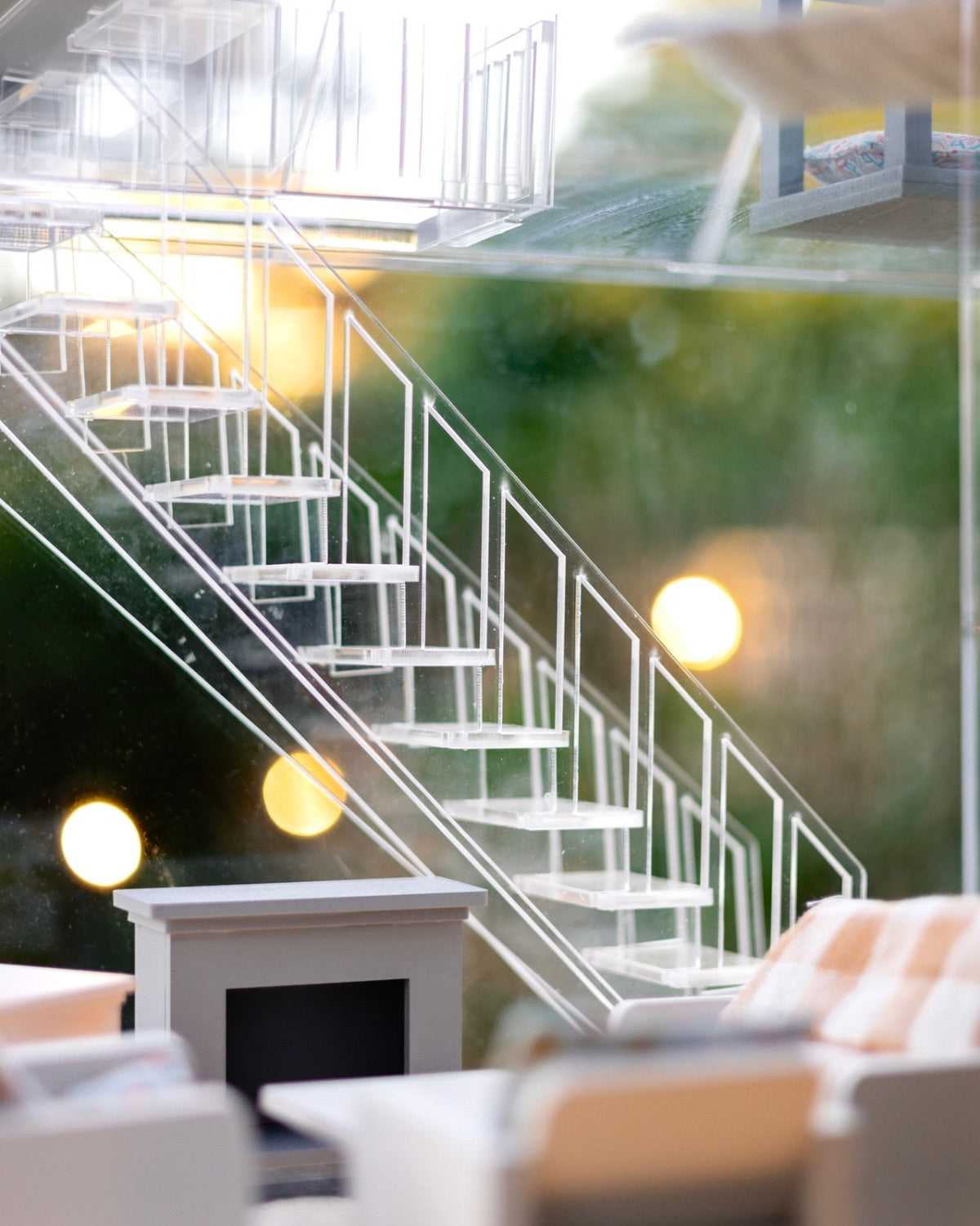 Close-up of the  staircase inside the Crystal Rome Collector's Edition with miniature living room furniture in the foreground.