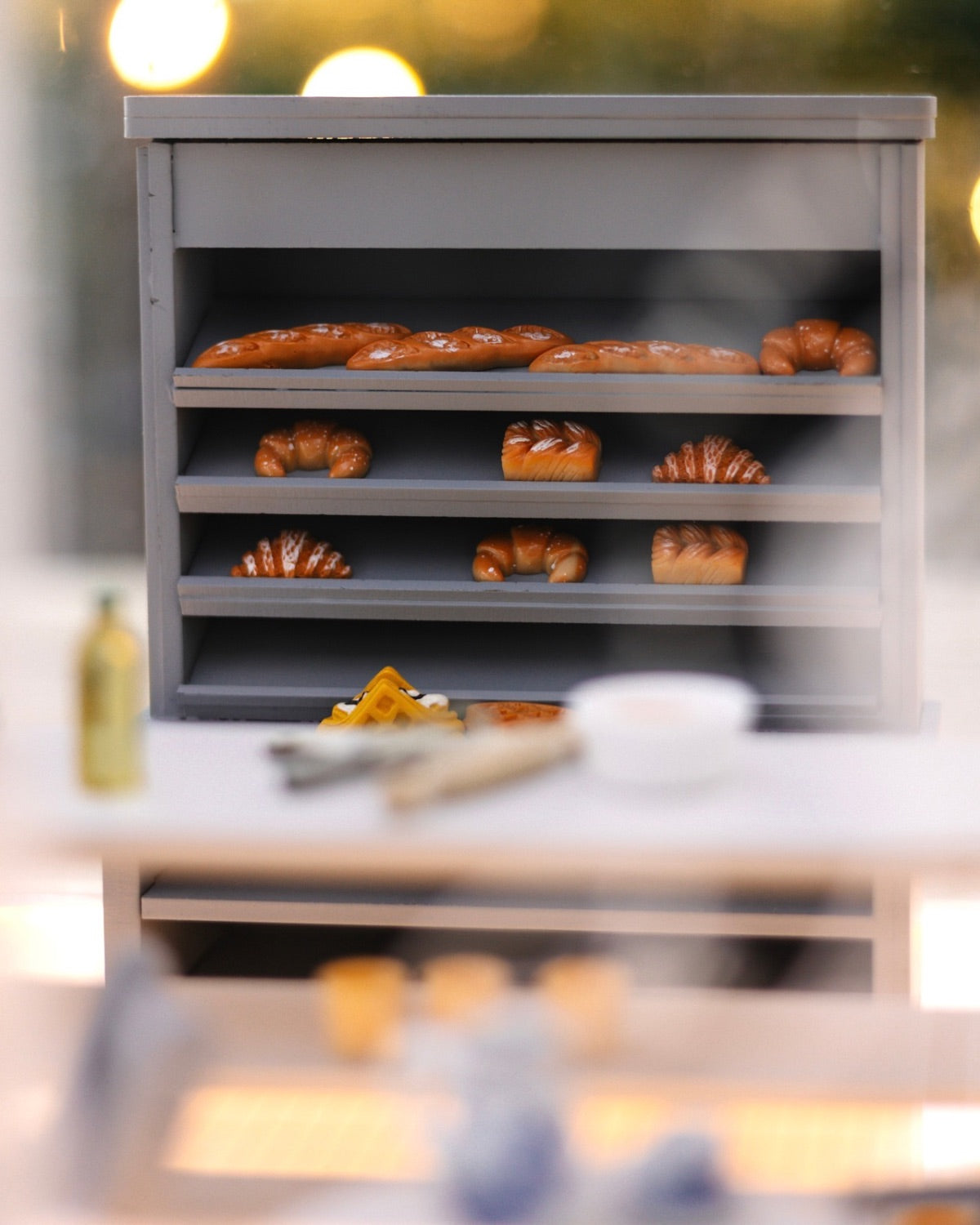 Close-up of the bakery shelf filled with miniature bread and pastries inside the Crystal Rome Collector's Edition.