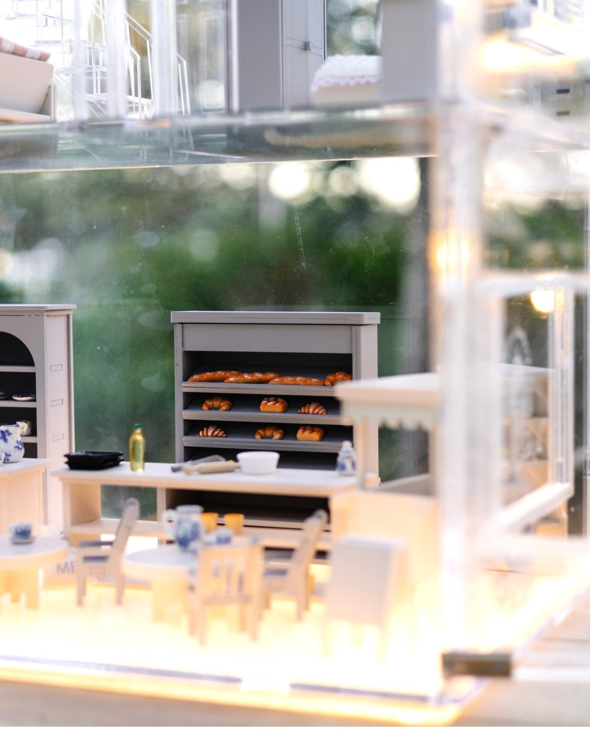 Close-up of the café area inside the Crystal Rome Collector's Edition, featuring miniature tables, chairs, and a bakery display.