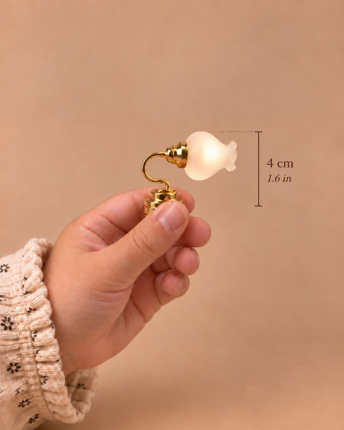 A 4 cm (1.6 in) wall light with a polished gold finish and softly glowing frosted glass shade, designed for 1:12 scale dollhouse interiors