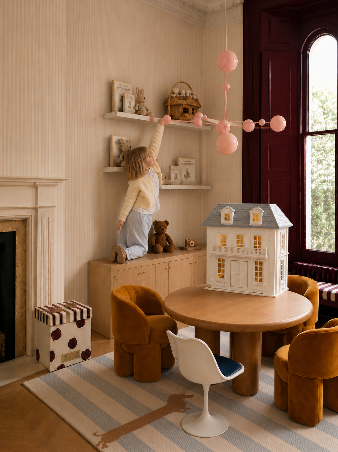 House of Hamptons dollhouse displayed on a wooden table in a children's playroom.