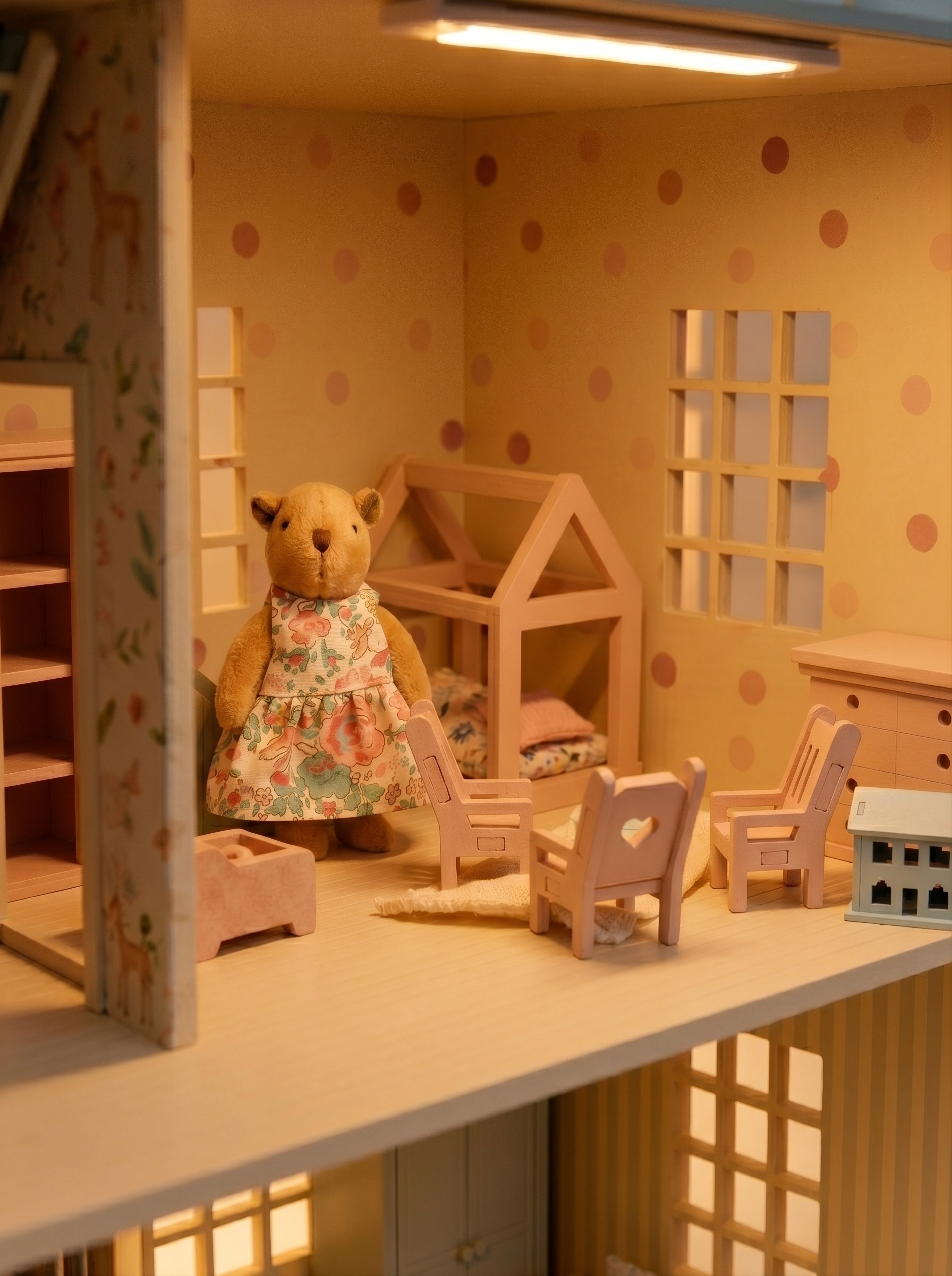 Bedroom inside the House of London wooden dollhouse featuring Little Forest Animals doll figures, miniature furniture, and warm interior lighting.