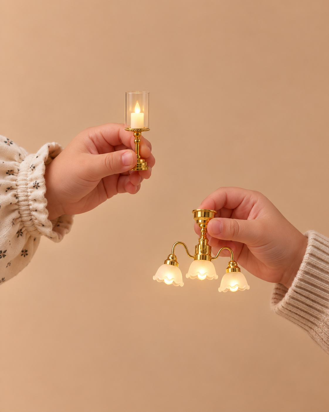 Hands holding a miniature brass hurricane lamp and three-arm chandelier for dollhouses.