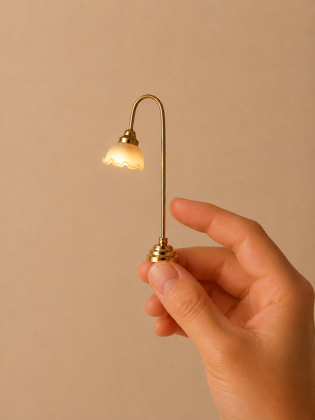 Curved brass floor lamp with a lit white glass shade.