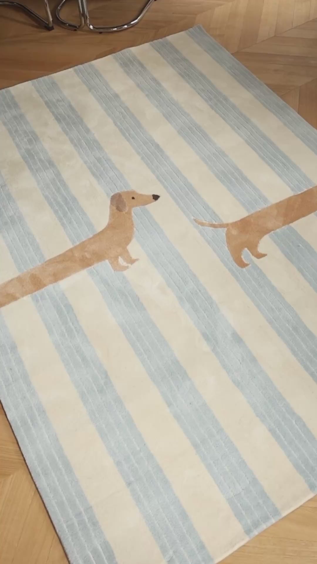 The Dachshund rug featuring soft blue stripes and a playful dachshund design in a family playroom.