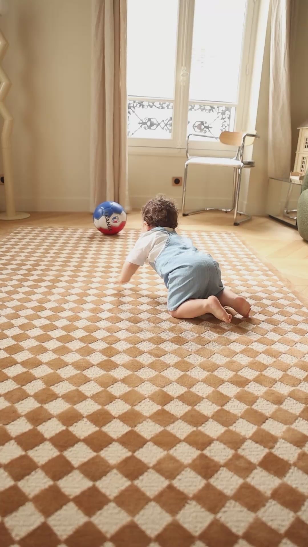 The Diamond rug with a classic diamond pattern in a bright family playroom.