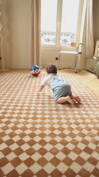 The Diamond rug with a classic diamond pattern in a bright family playroom.