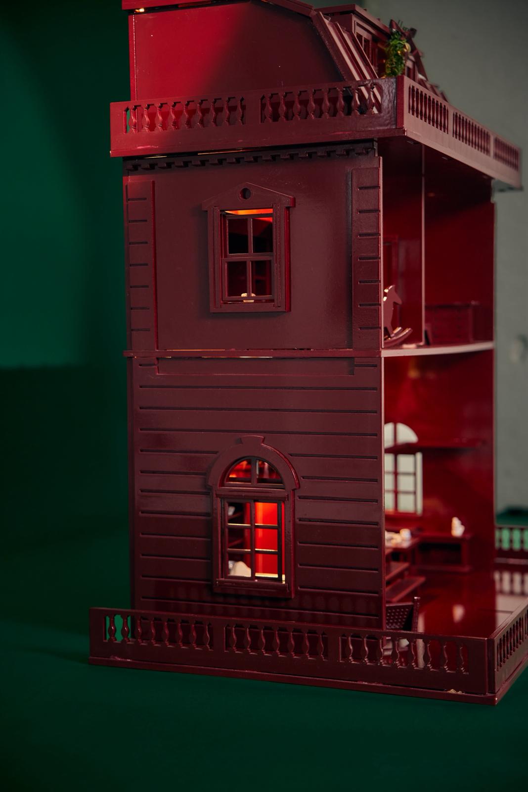 Red dollhouse with detailed