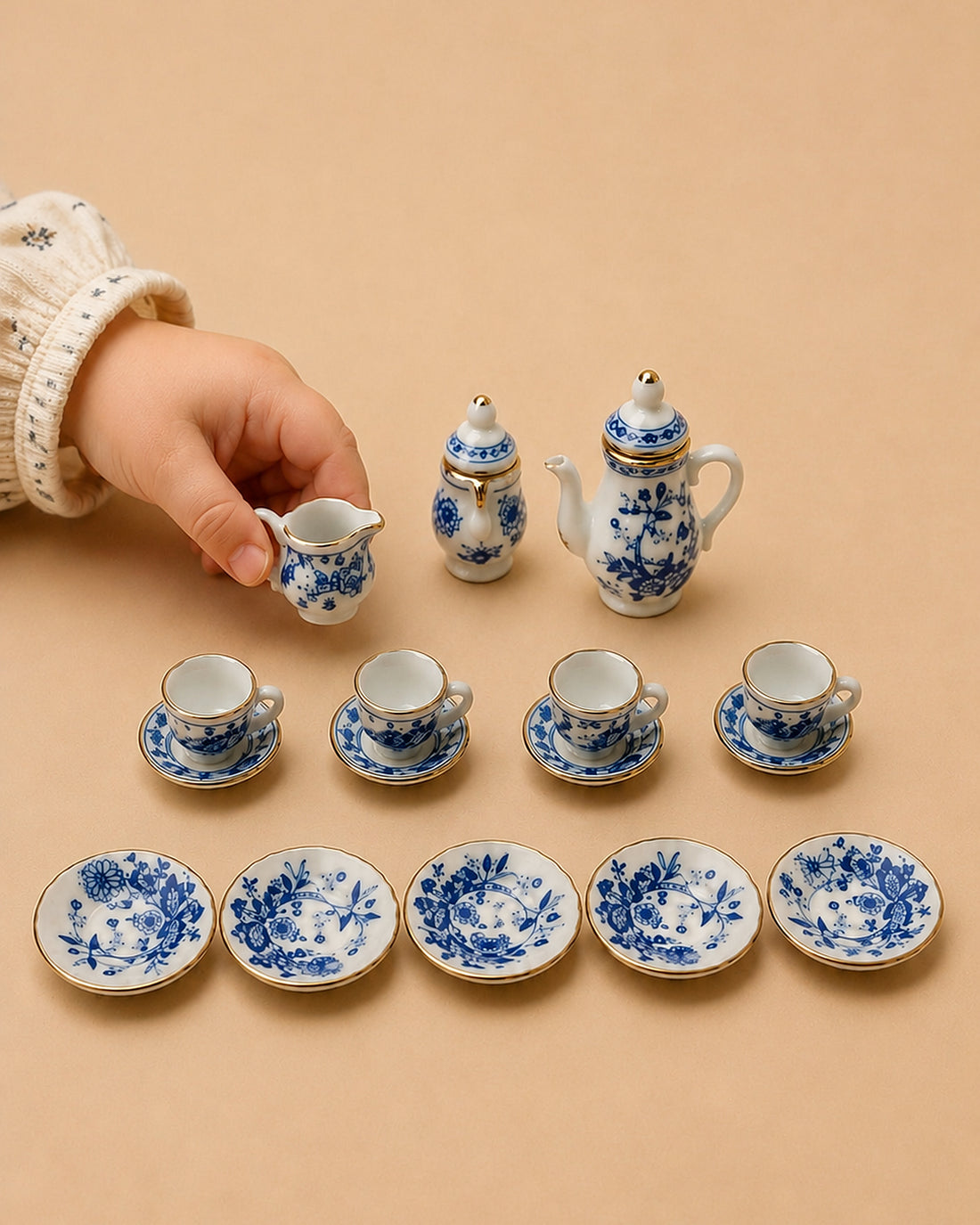 Miniature porcelain tea set — the full 17-piece layout of cups, saucers, teapot and serving tray.