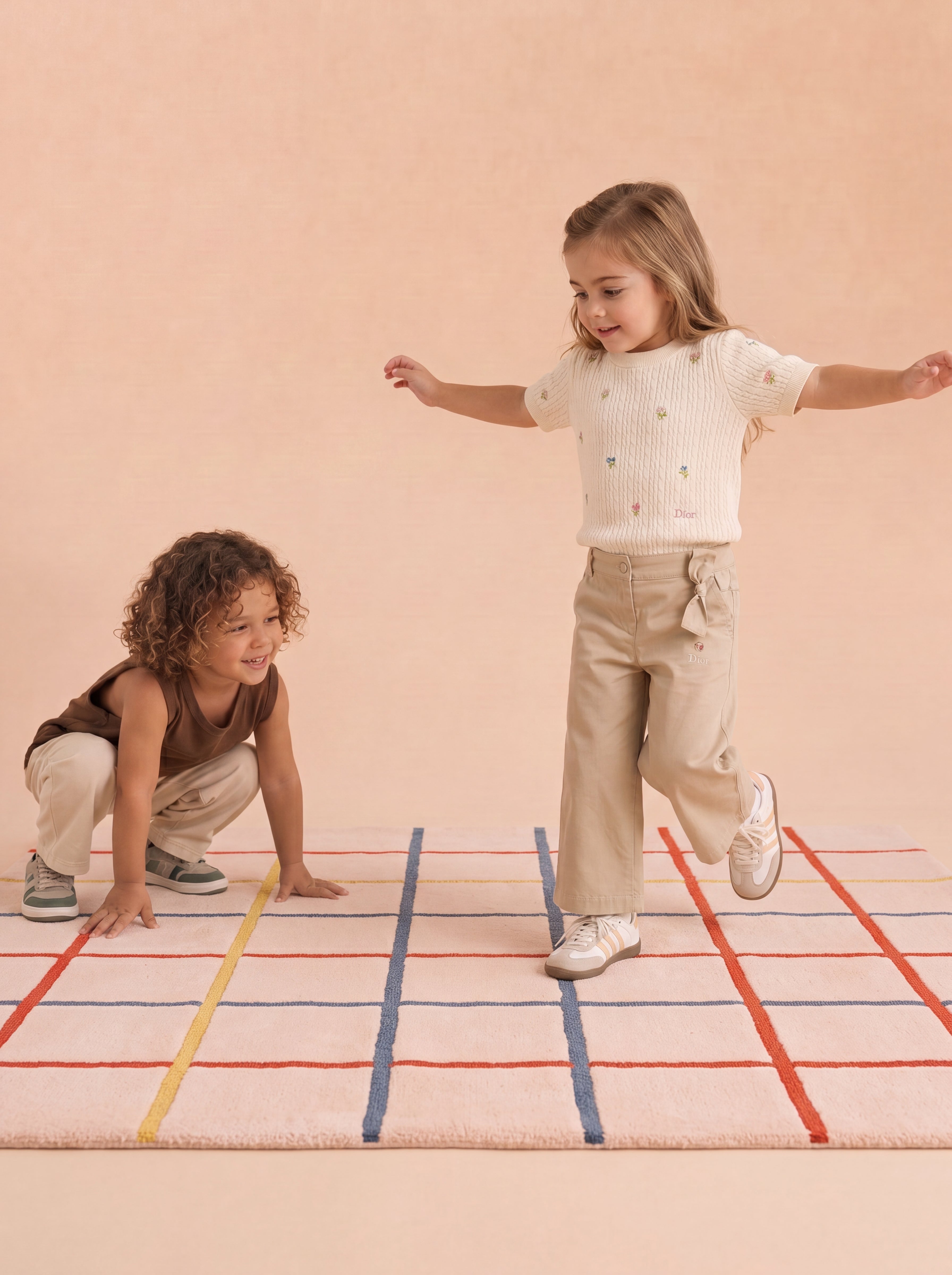 Two children playing on The Palette rug.