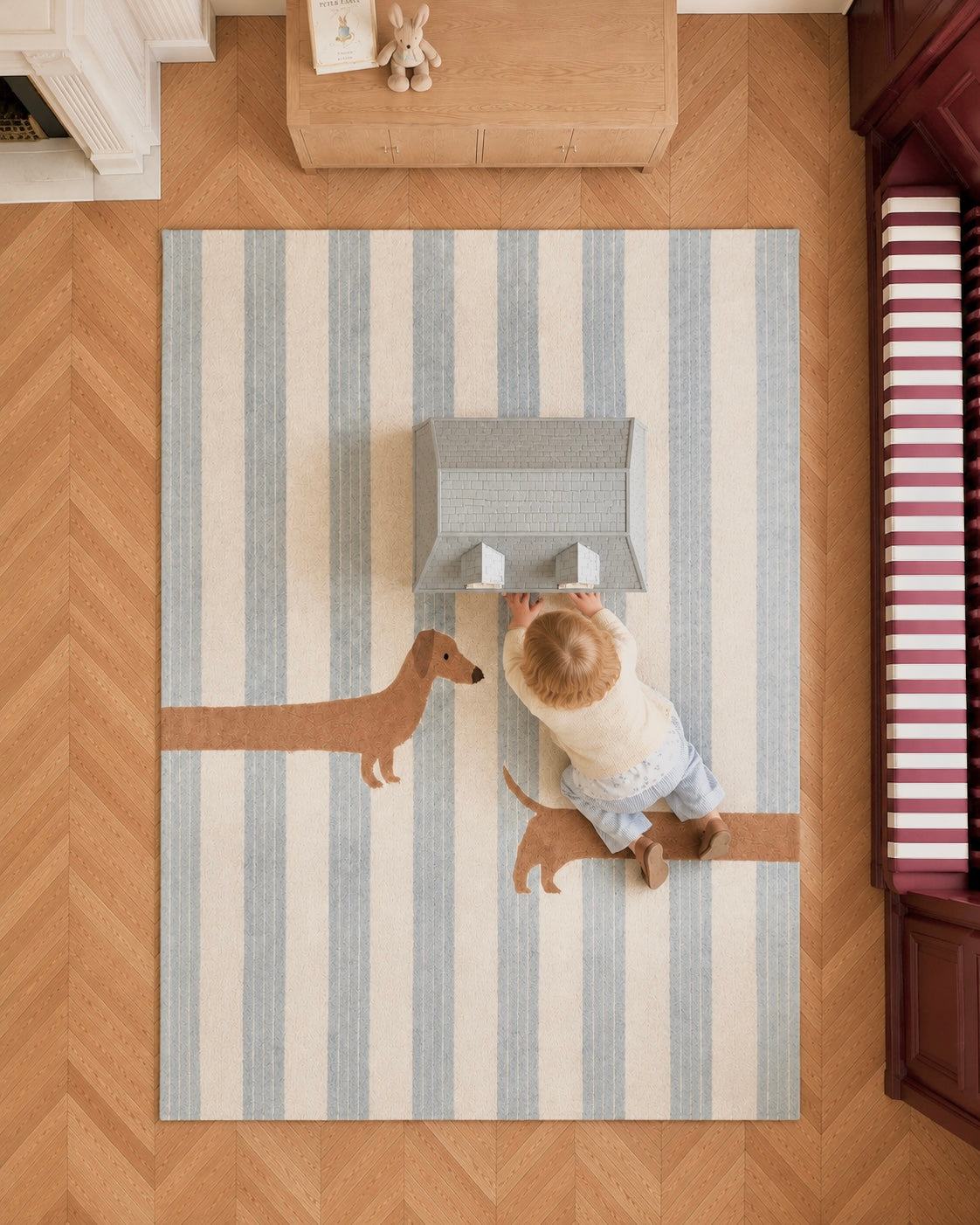 Overhead view of The Dachshund rug featuring soft blue stripes and a playful dachshund design.