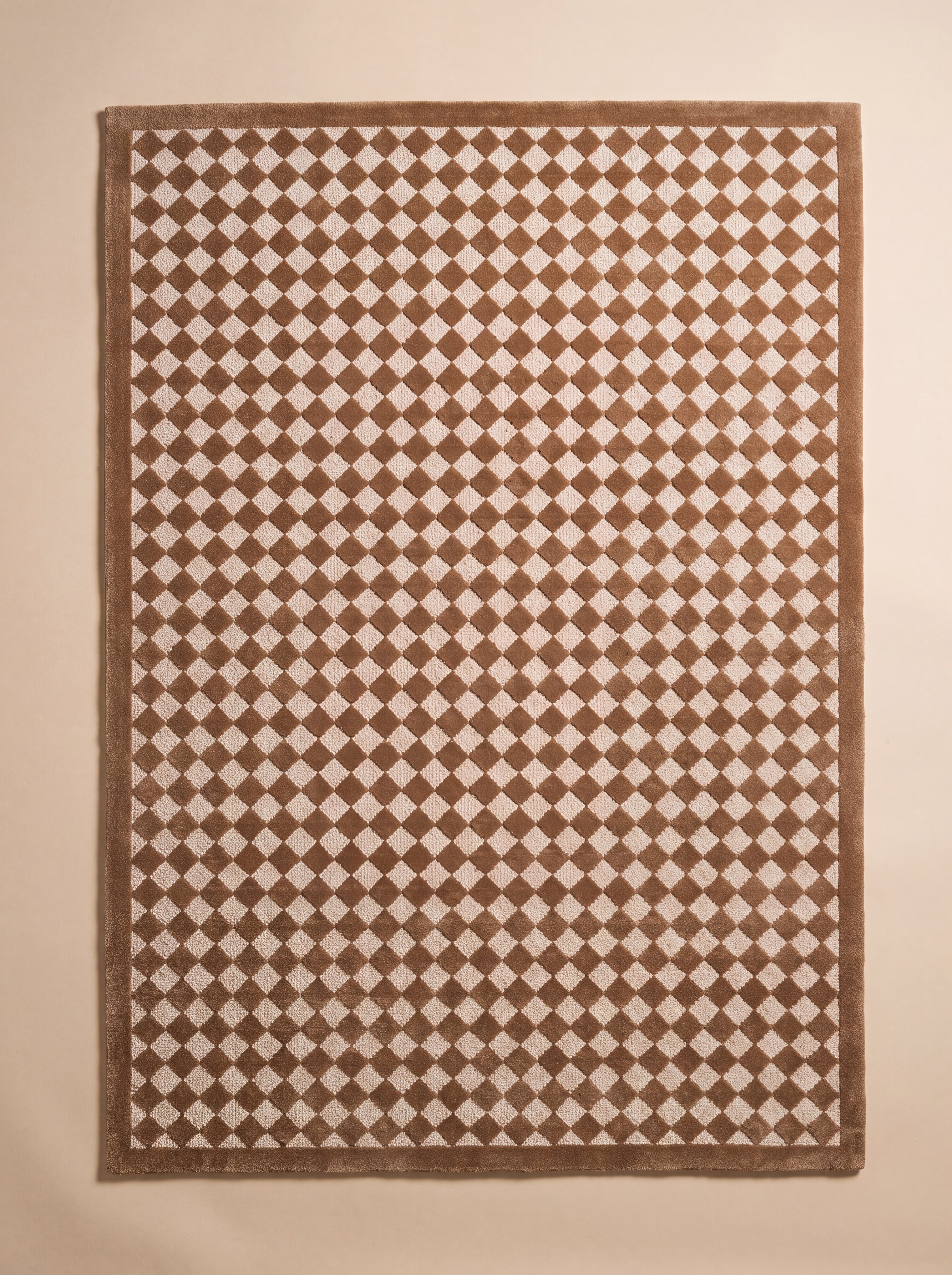 Full view of The Diamond rug featuring a classic caramel and cream diamond pattern.