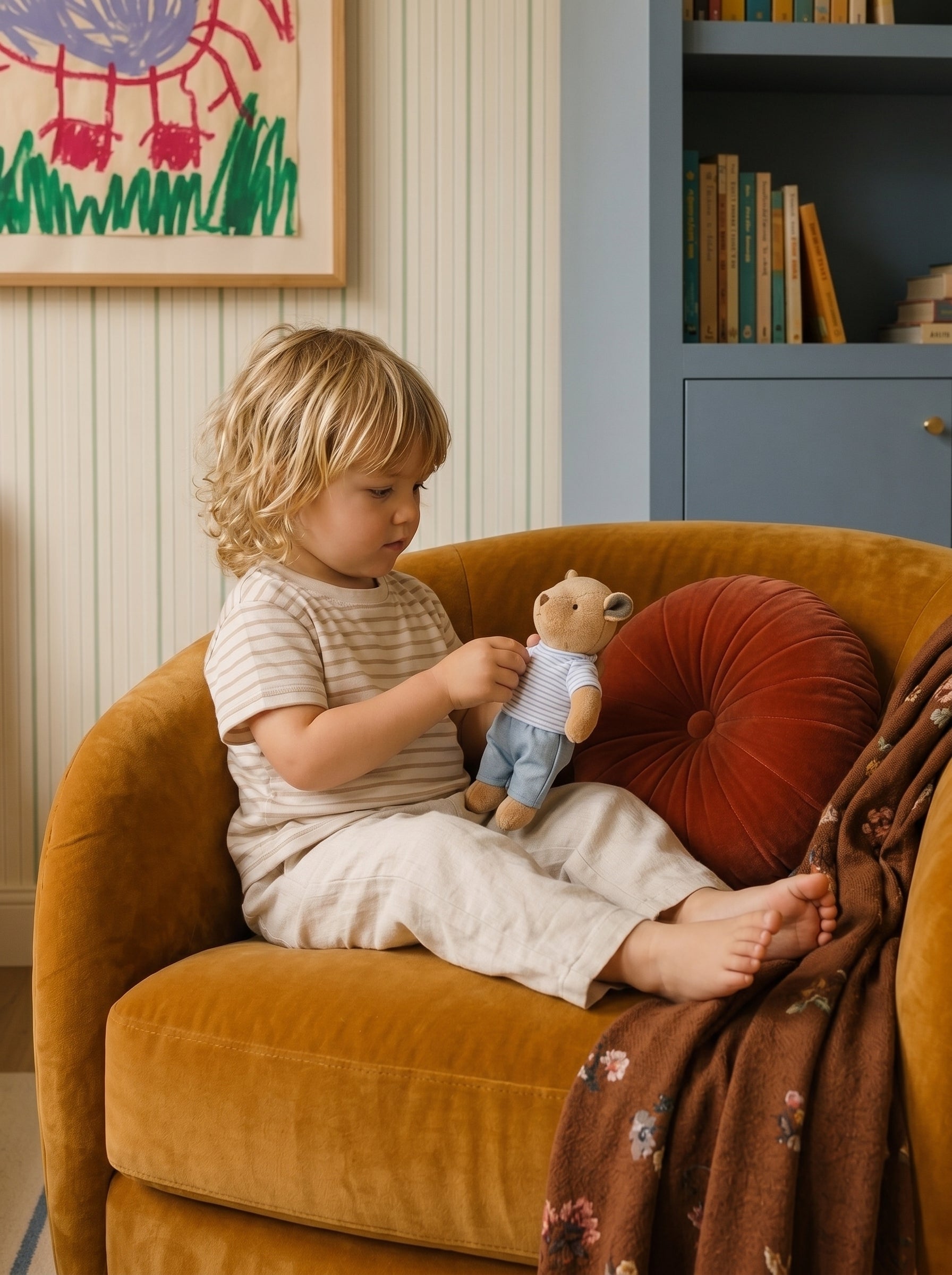 A Thompson Family plush toy being played with while sitting on an armchair.